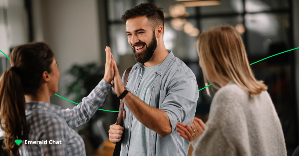 image of two females and one male, with the male doing high five with a female